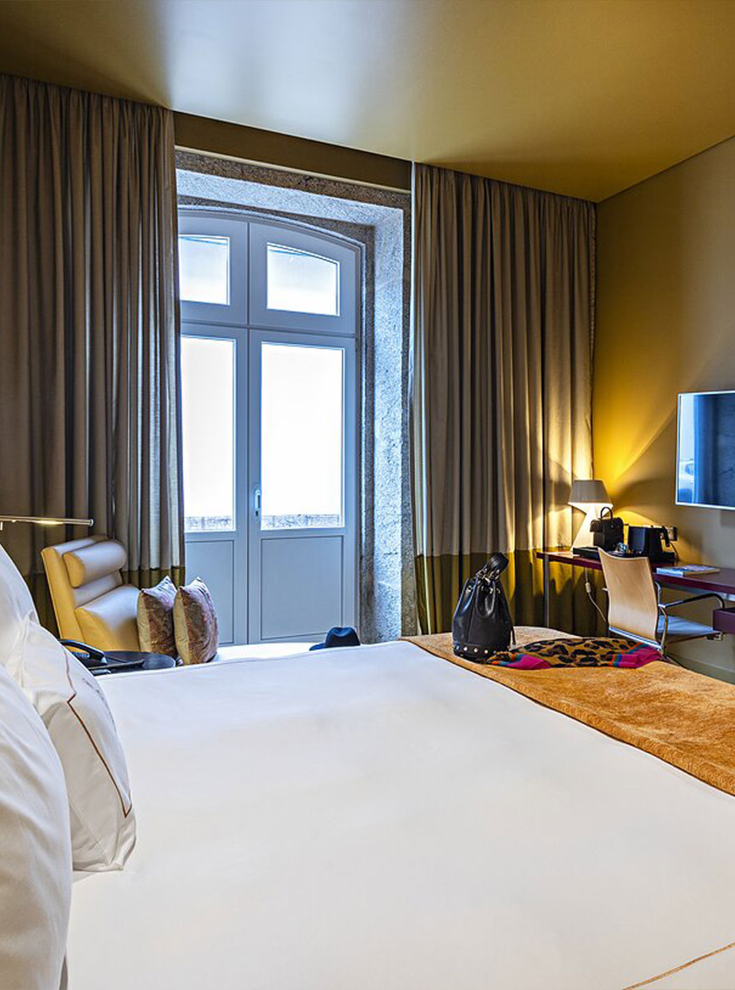 Pestana Palácio do Freixo’s Classic room has a TV in front of the double bed and a window