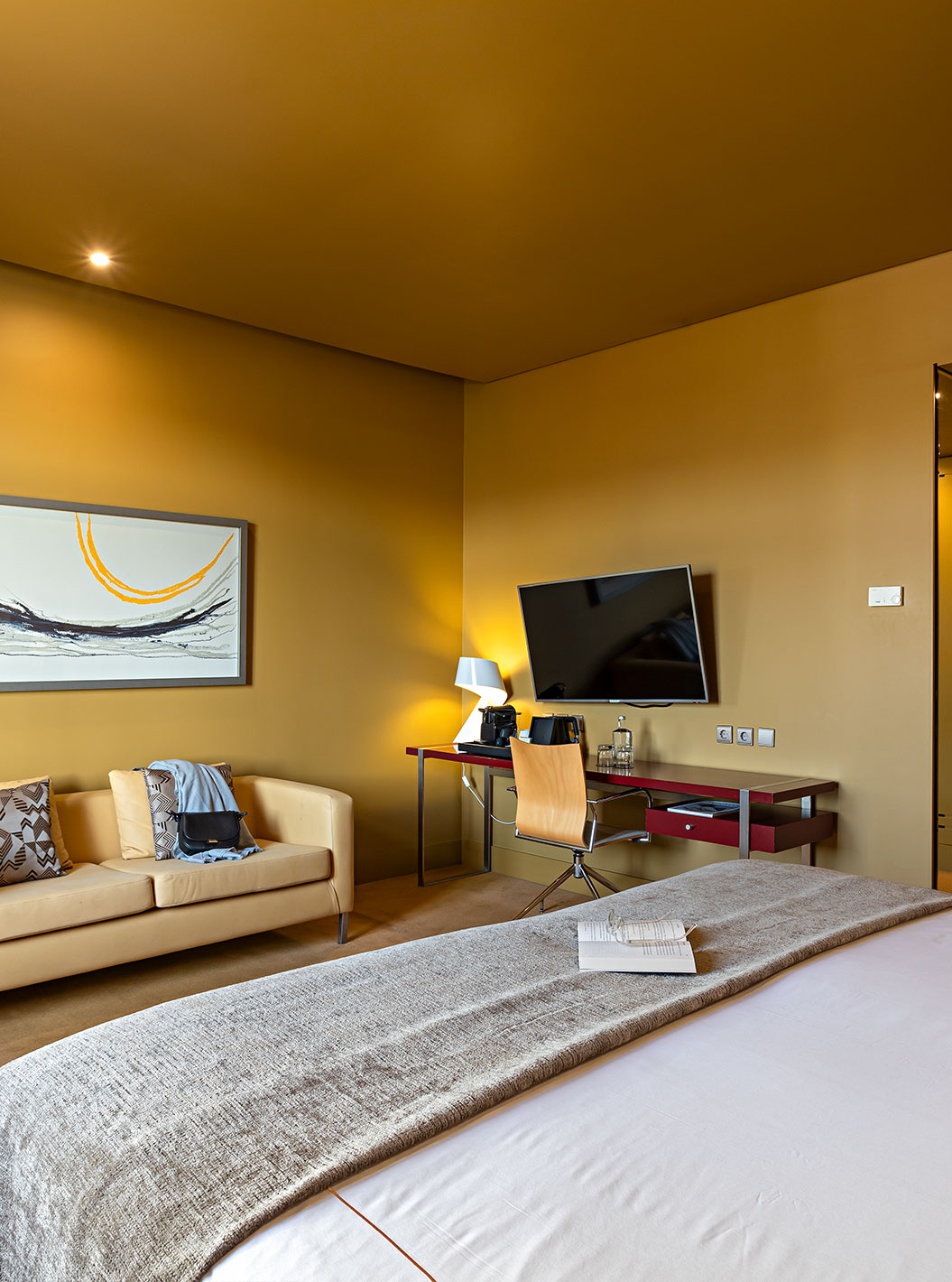 The Executive has a double bed, a sofa, a TV, and a desk