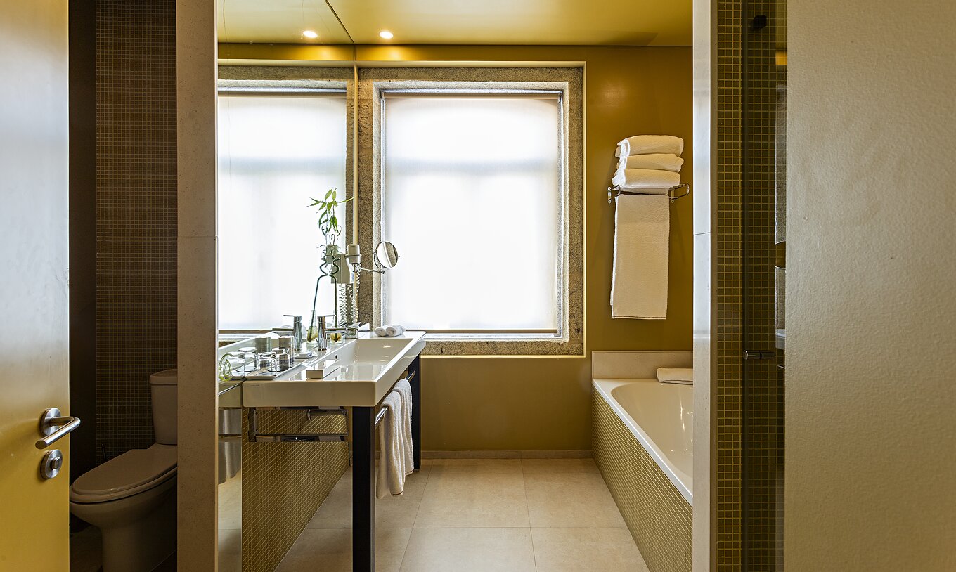 The Standard Suite has a bathroom with bathtub, sink, and separate toilet area
