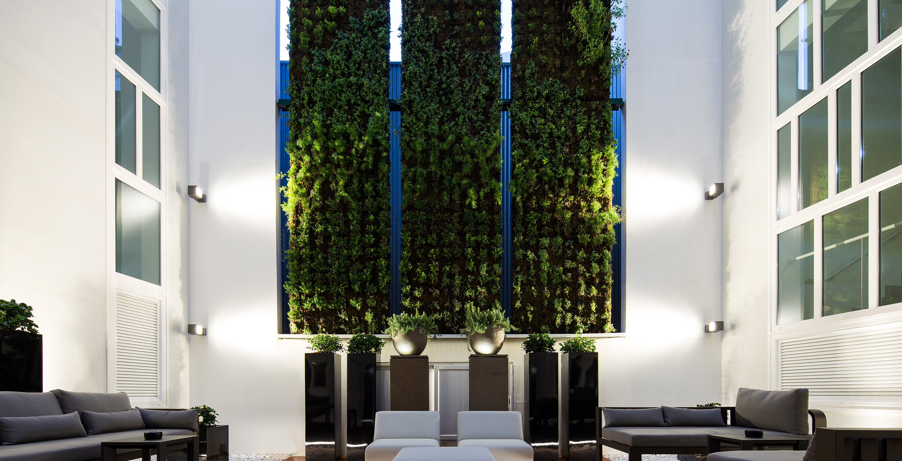 Pestana Porto - A Brasileira, a 5-star hotel in Porto, has a courtyard with a green wall of plants and sofas