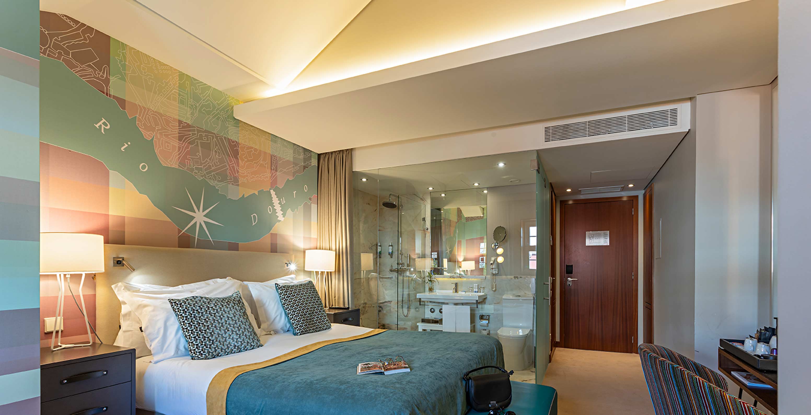 The Classic at Pestana Vintage Porto has a double bed with a blue cover and a desk with a chair