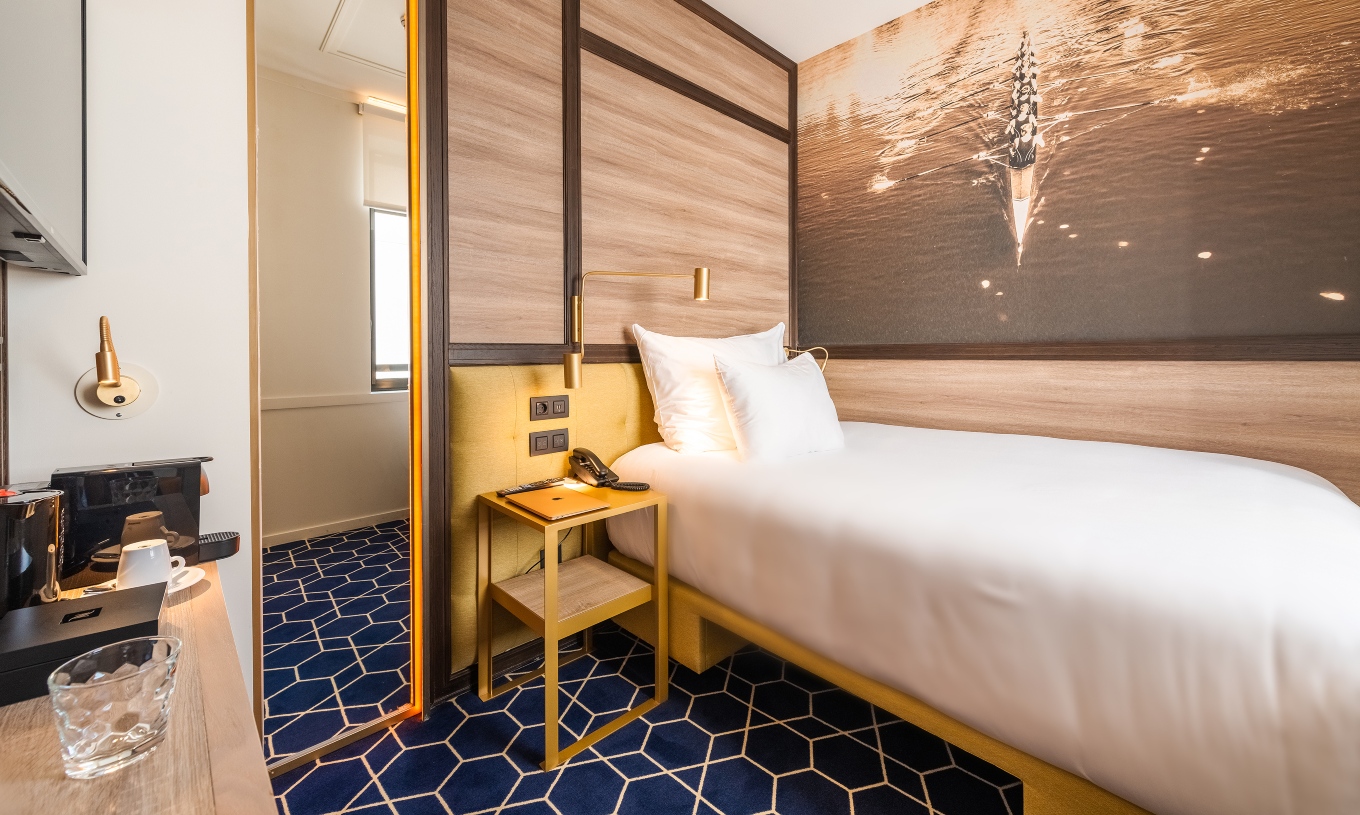 The Cozy Room at Pestana CR7 Gran Vía Madrid has a single bed, coffee machine, a mirror, and a window
