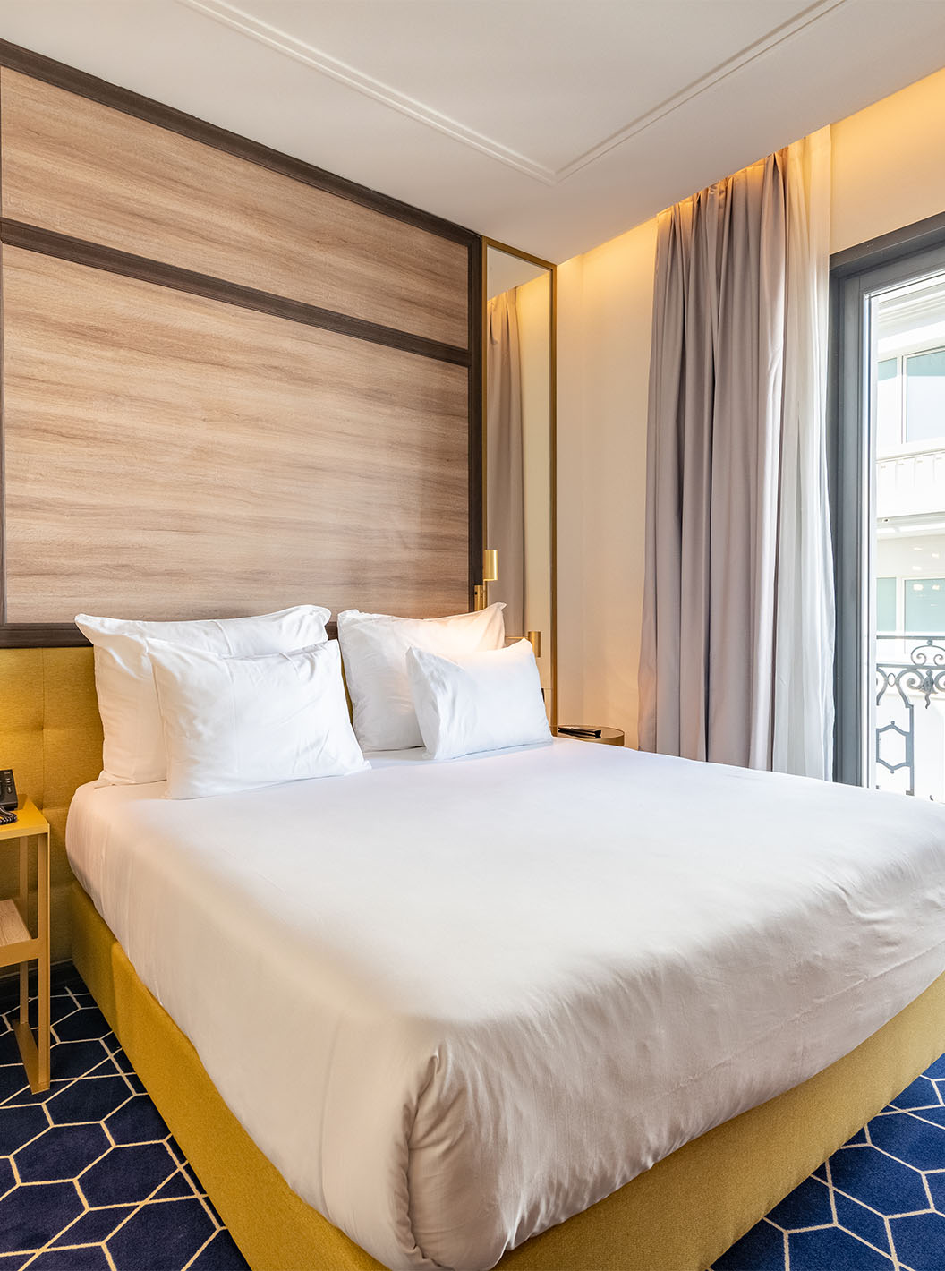 The Premium Grand Room with Balcony at Pestana CR7 Gran Vía Madrid features a double bed and large windows