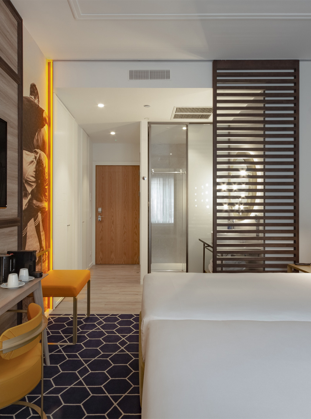 The Premium Room with View at Pestana CR7 Gran Vía Madrid has two beds and a wooden partition for the bathroom