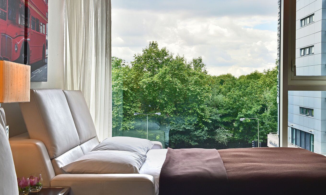 The Deluxe Family at Pestana Chelsea Bridge has open sofa bed, London art, large window with view and curtains