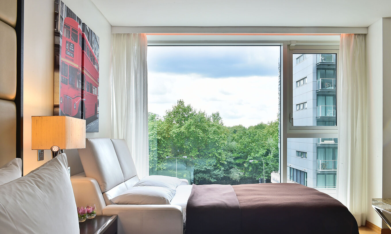 The Deluxe Family at Pestana Chelsea Bridge has open sofa bed, London art, large window with view and curtains