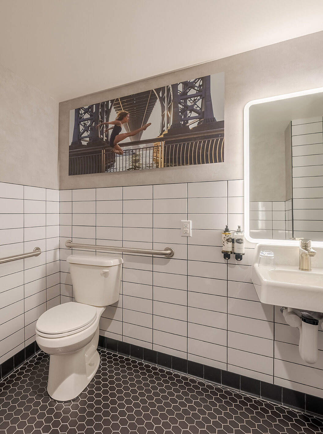 The Comfort ADA at Pestana CR7 Times Square has an adapted bathroom with toilet, sink, and mirror