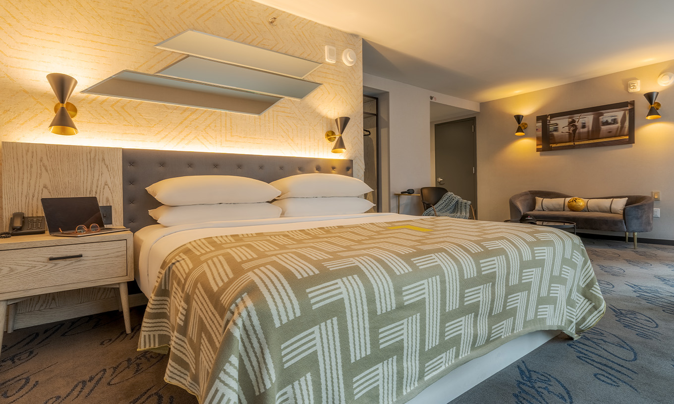 The ADA Junior Suite with Balcony and View at Pestana CR7 Times Square has a double bed and a seating area at the back