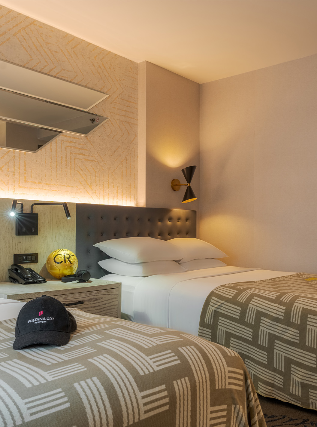 The Superior Double ADA at Pestana CR7 Times Square has two beds with a bedspread with the number seven and a desk