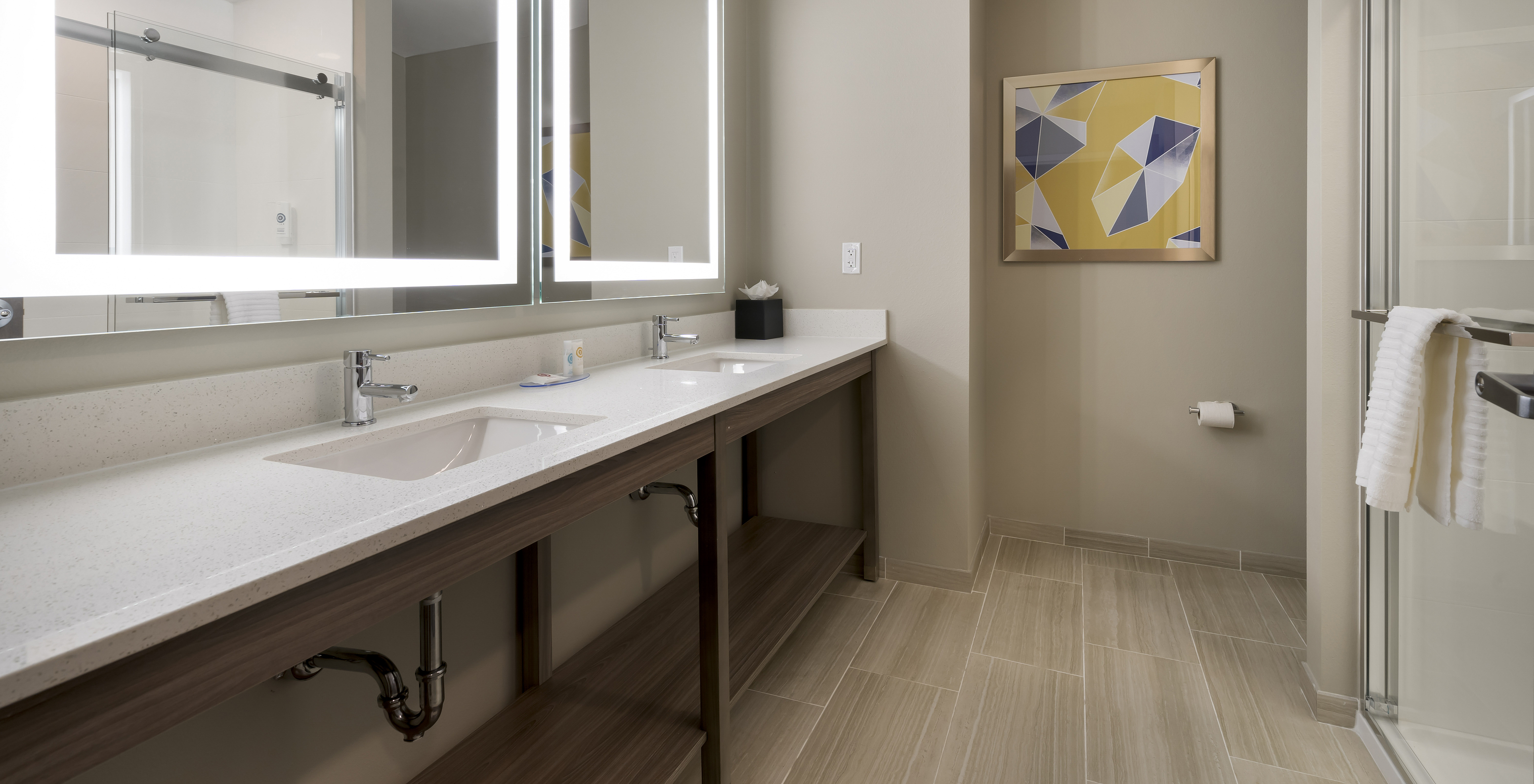 The Master Double Queen Suite at Pestana Orlando Suites Lake Buena Vista features a bathroom with two mirrors and a sink