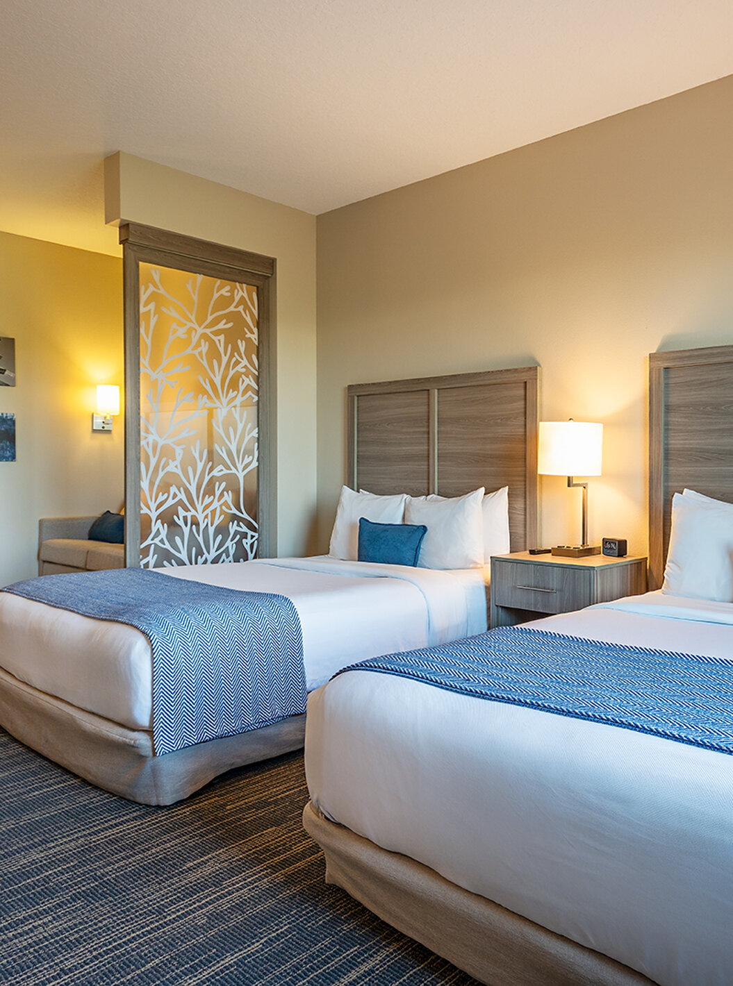 Connected King and Double Queen Suites at Pestana Orlando Suites Lake Buena Vista with two beds and warm lighting
