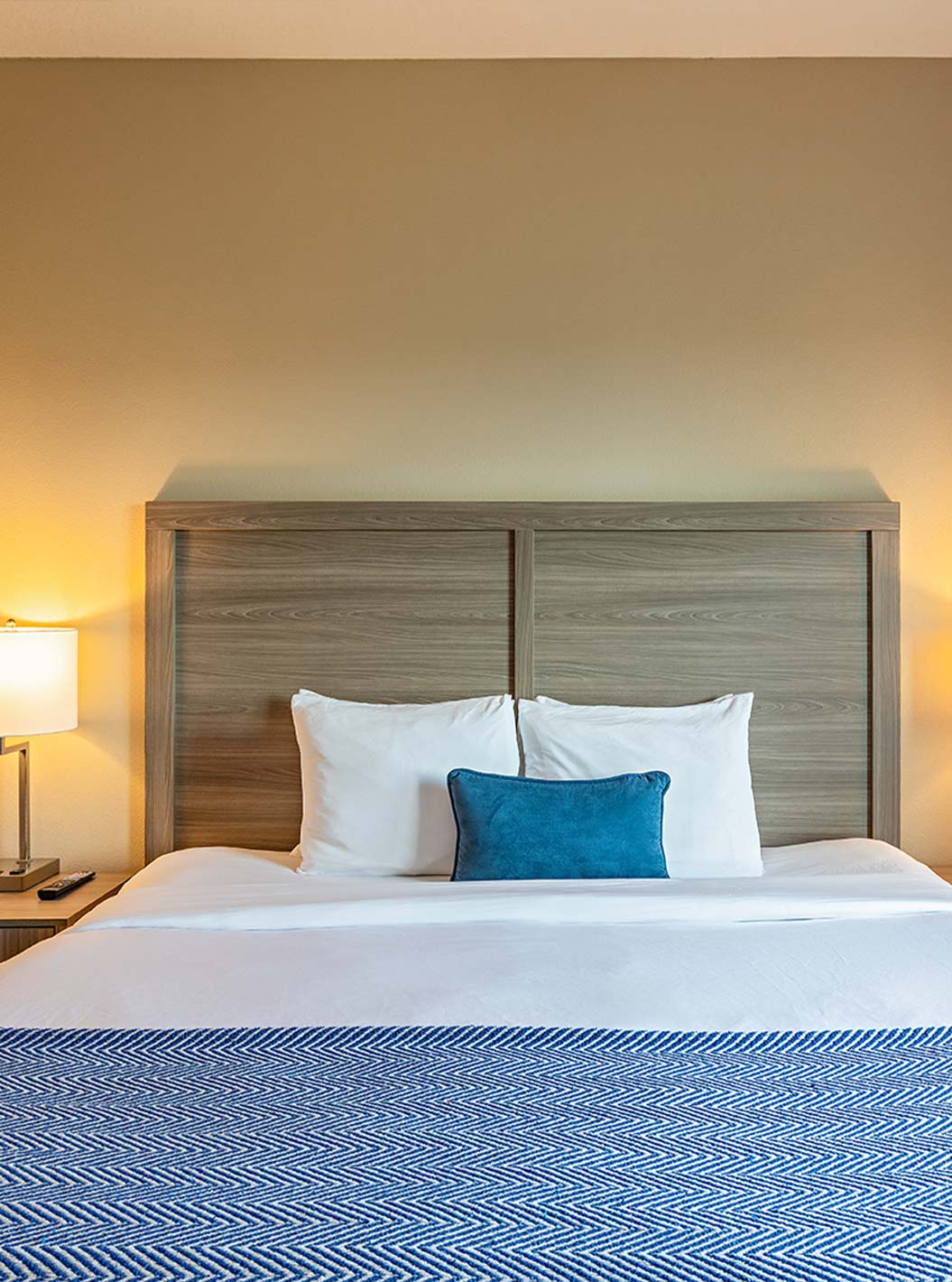 Connected King and Double Queen Suites at Pestana Orlando Suites Lake Buena Vista featuring a king bed with lamps