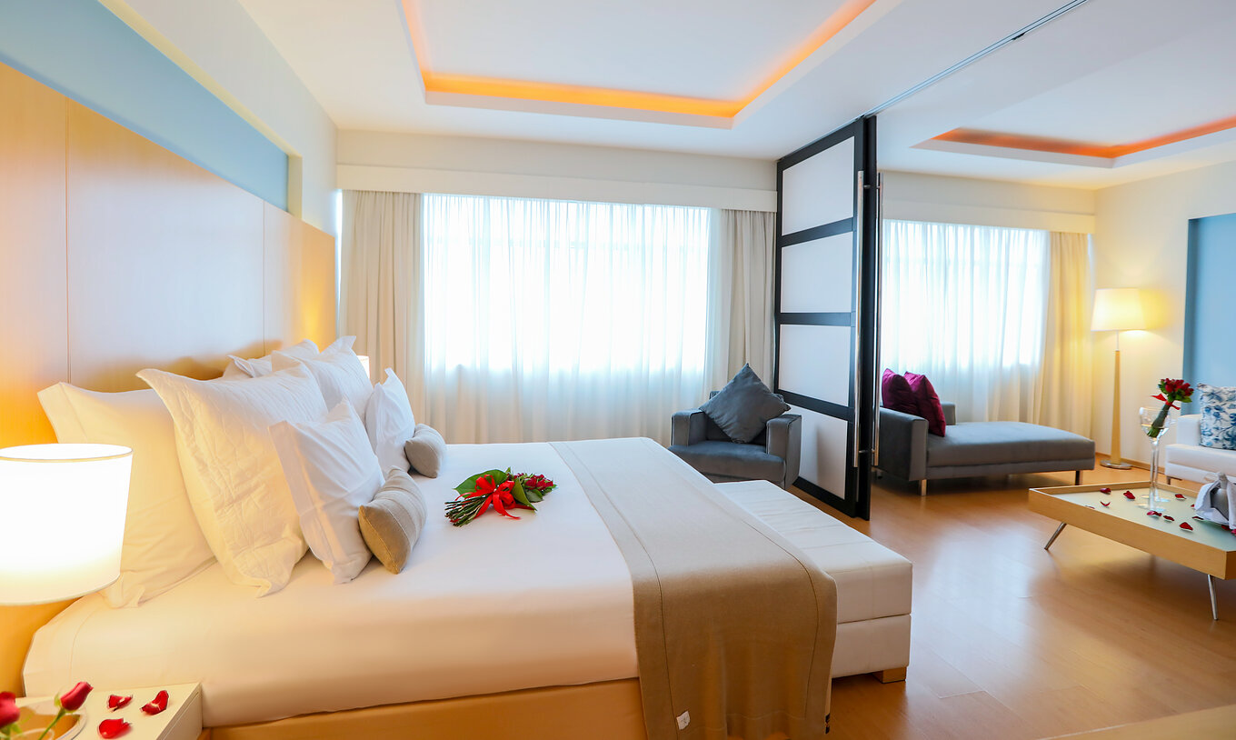 The King Master Suite at Pestana Curitiba has a room with a double bed and a living room with a sofa that can be an extra bed