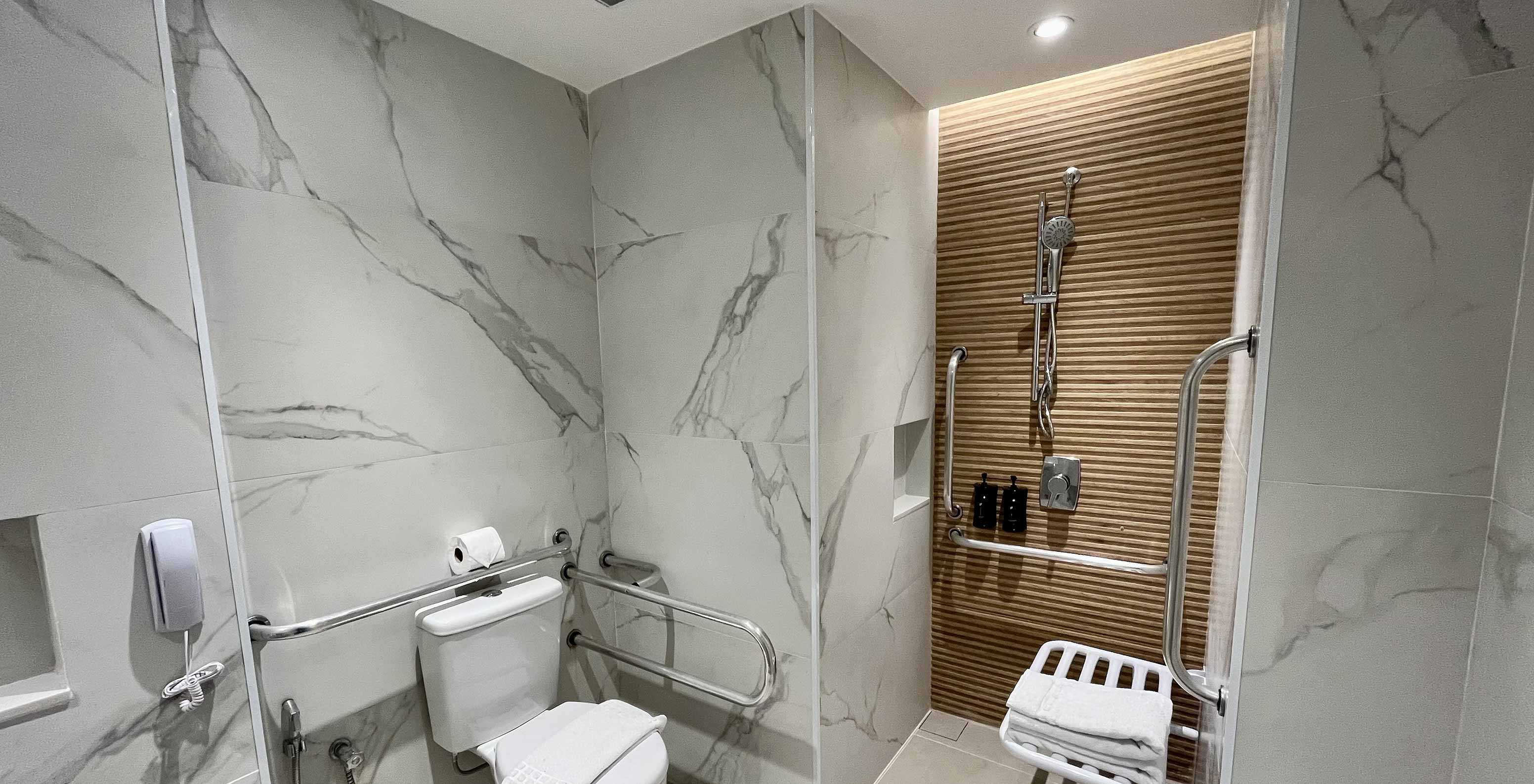 The Semi-Adapted Room at Pestana Rio Atlântica has an accessible bathroom with toilet, shower and grab bars