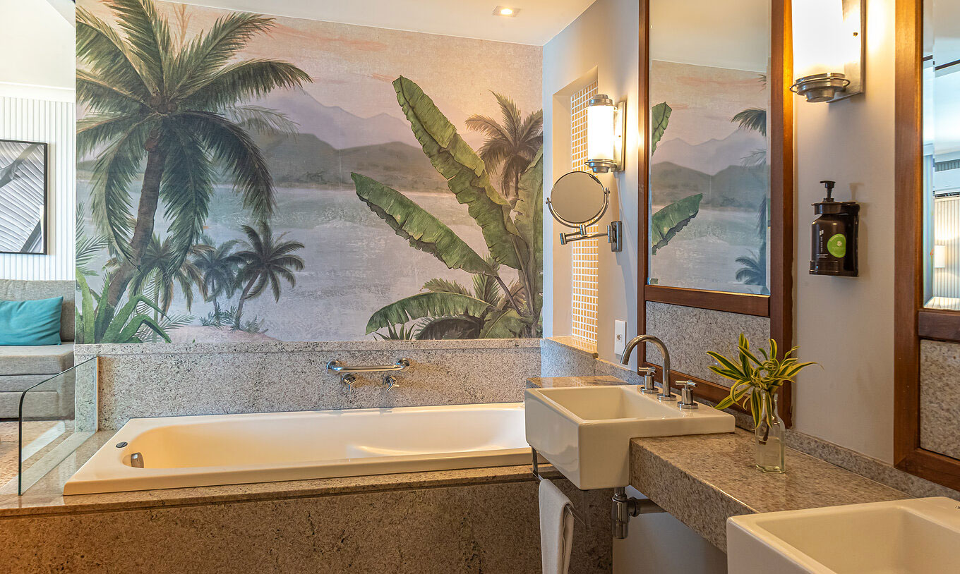 The Oceanic Suite at Pestana Rio Atlântica has a bathroom with marble tub, double sinks and mirror.