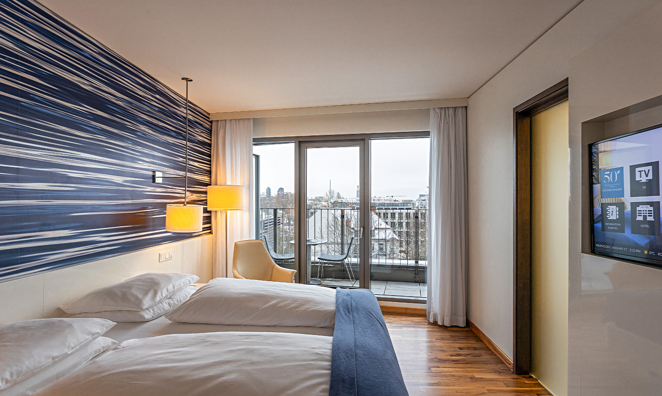 Premium Room with Balcony at Pestana Berlin Tiergarten has TV, balcony with city view, and an armchair