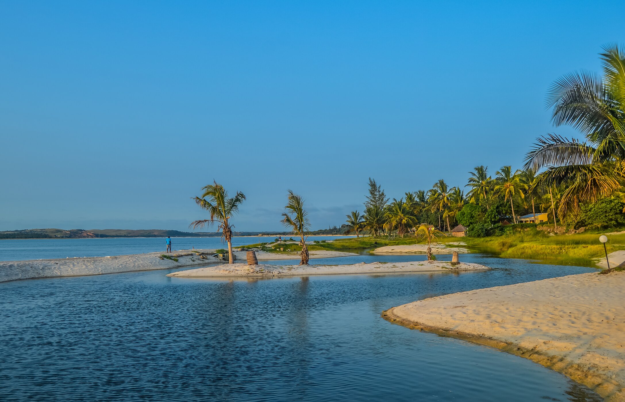 Bilene Beach in Maputo at sunset, with a small lagoon between the sand
