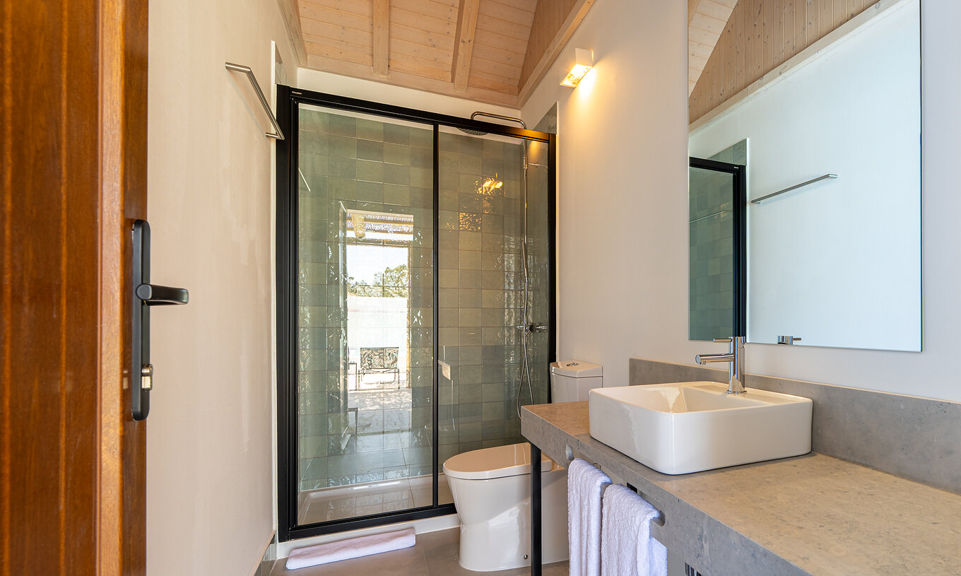 The Premium Villa at Pestana Comporta Village Residences has a bathroom in gray tones with a shower