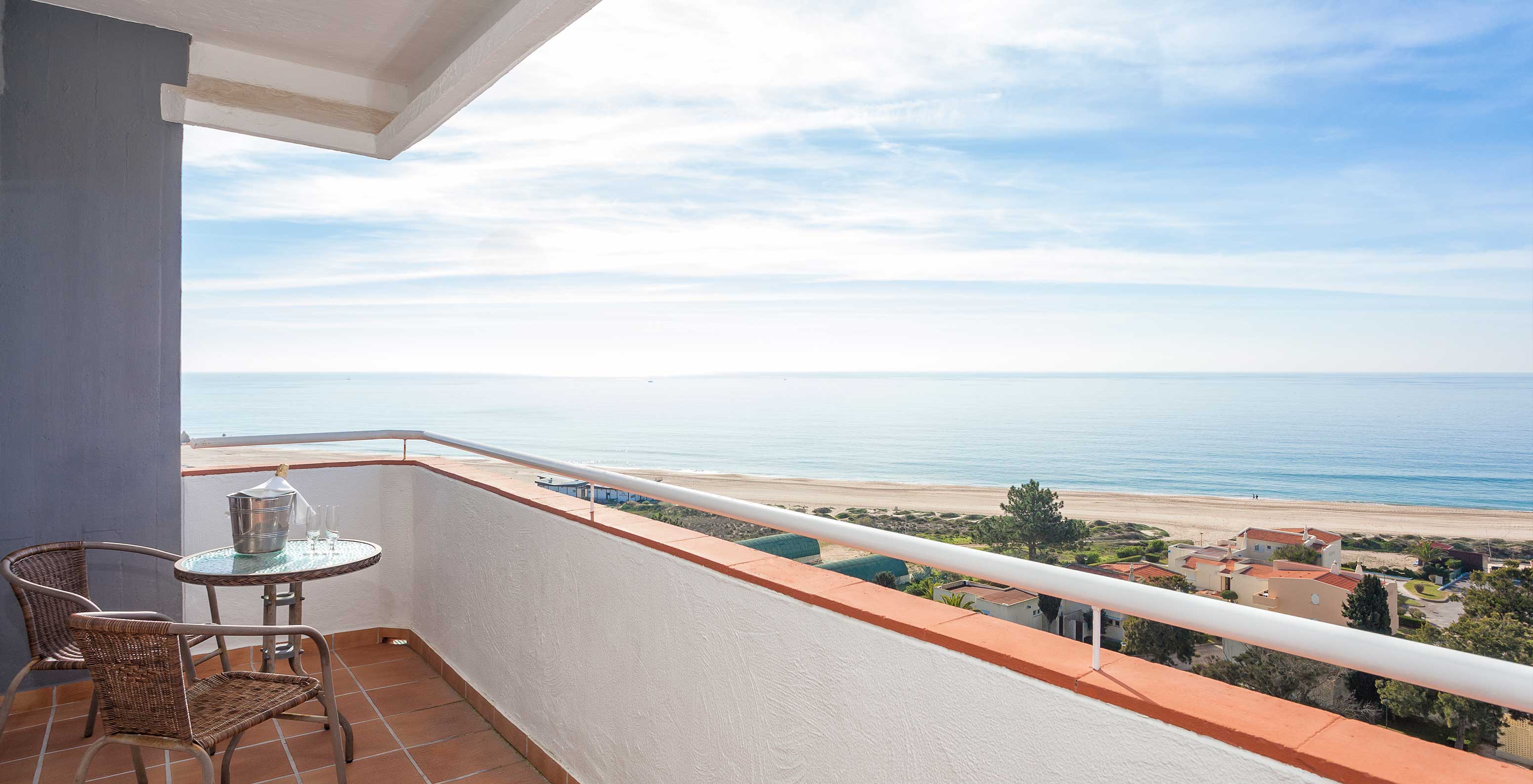 The Superior Sea View Studio at Pestana Alvor Atlântico has a large balcony with a table and chairs for the view