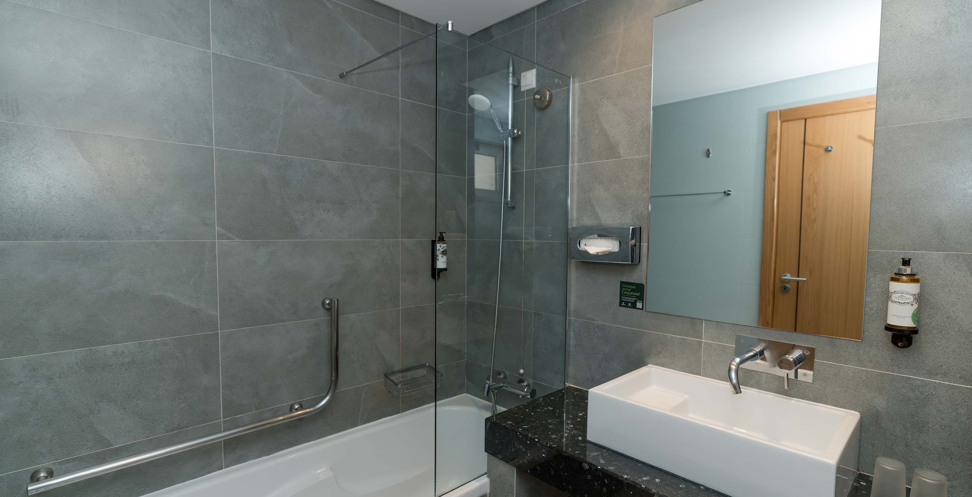 Apartment T1 Garden View at Pestana Alvor Beach Villas has a bathroom with bathtub and sink with mirror