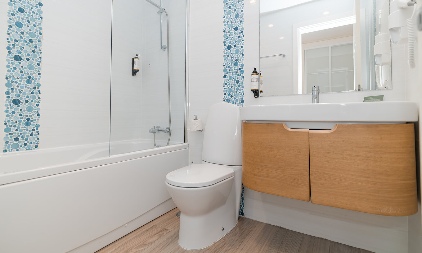 Villa 2 Bedrooms Superior Garden View at Pestana Alvor Beach Villas has a bathroom with bathtub, sink and mirror