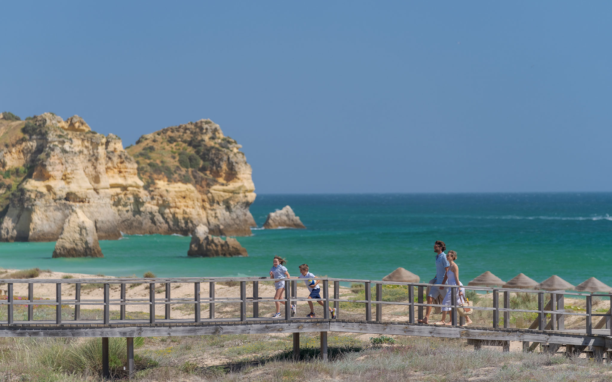 Family staying at Pestana Alvor Beach Villas, on the boardwalk to Alvor Beach