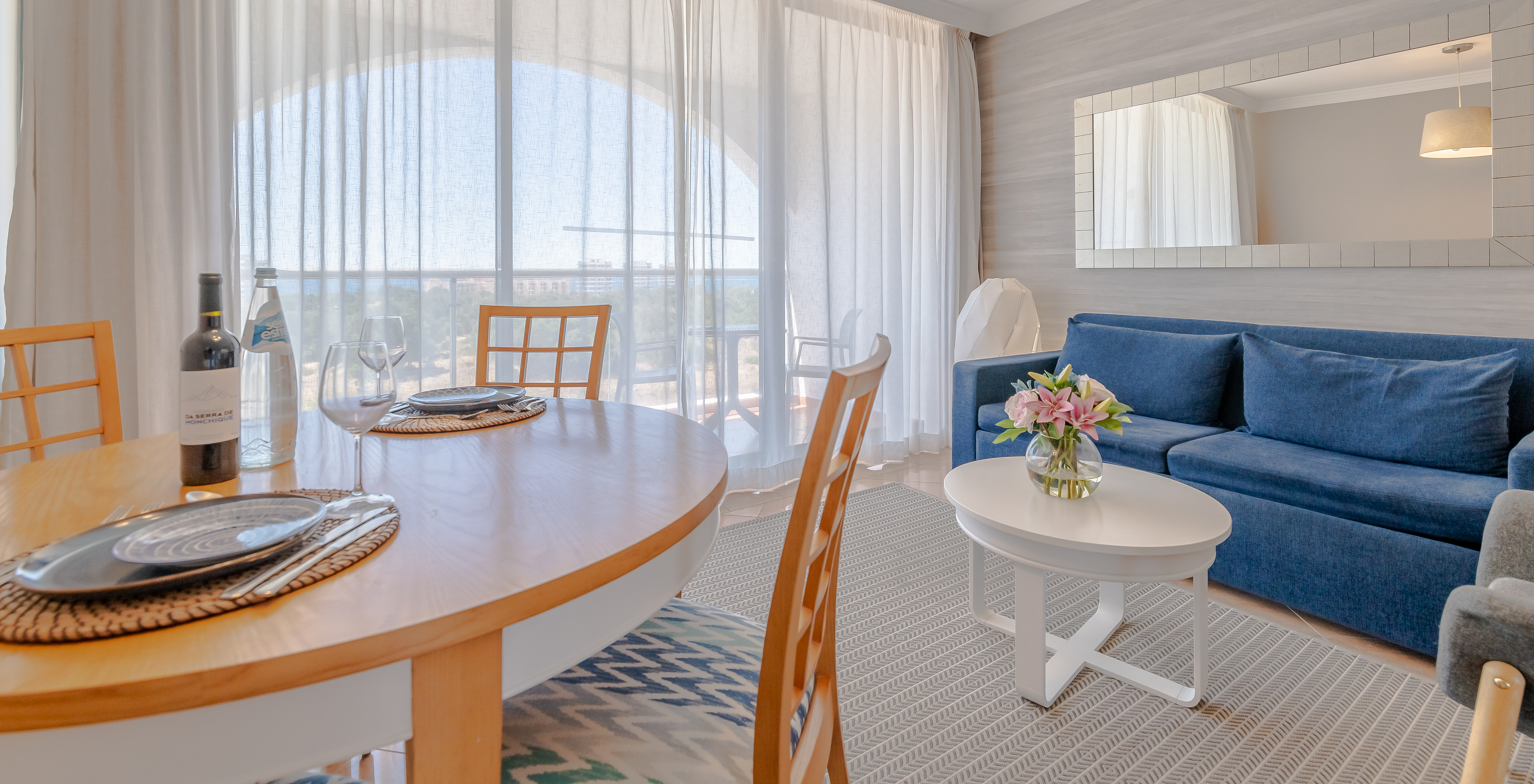 The T0 - Premium Studio at Pestana Alvor Park has a dining table, a sofa, and a balcony