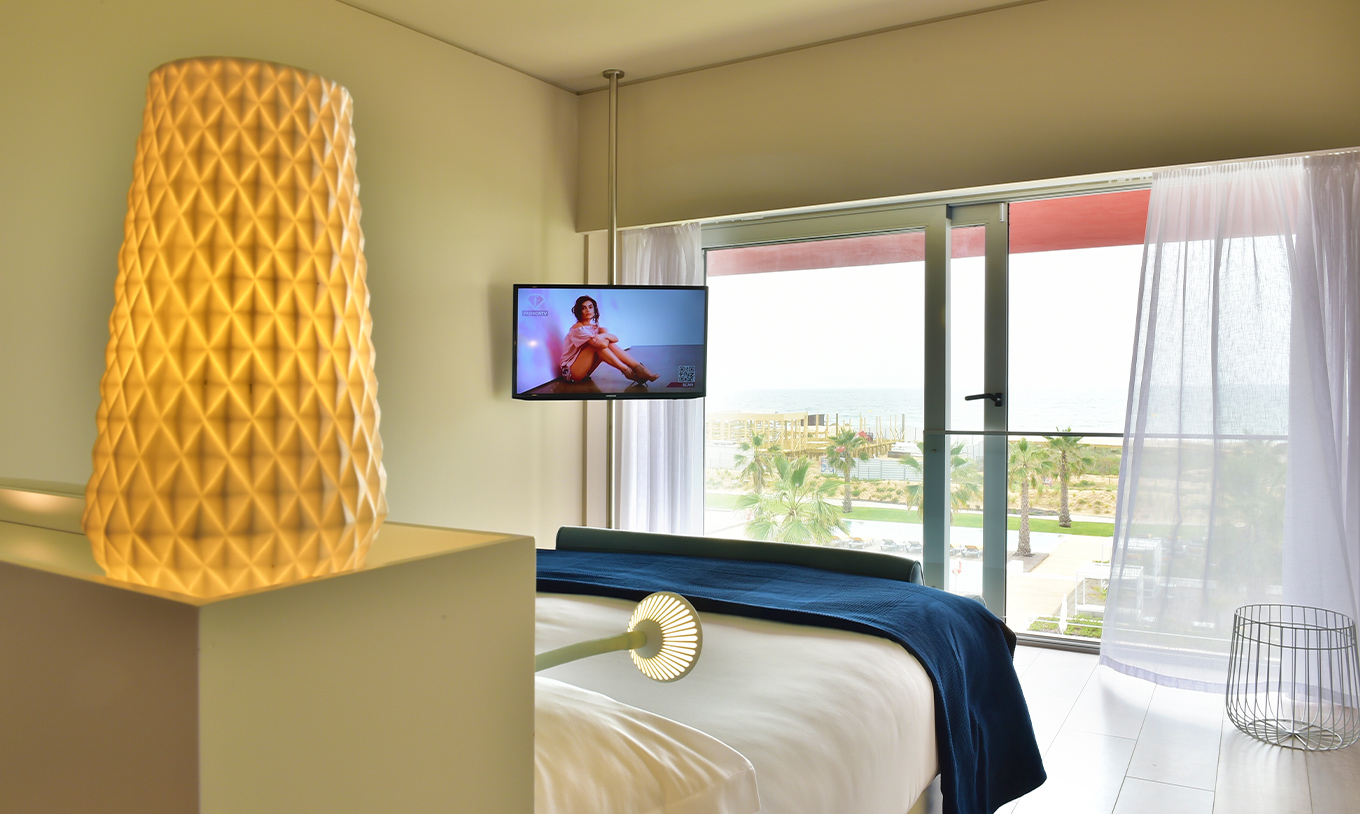 The Deluxe Sea View at Pestana Alvor South Beach has a double bed a TV and a window