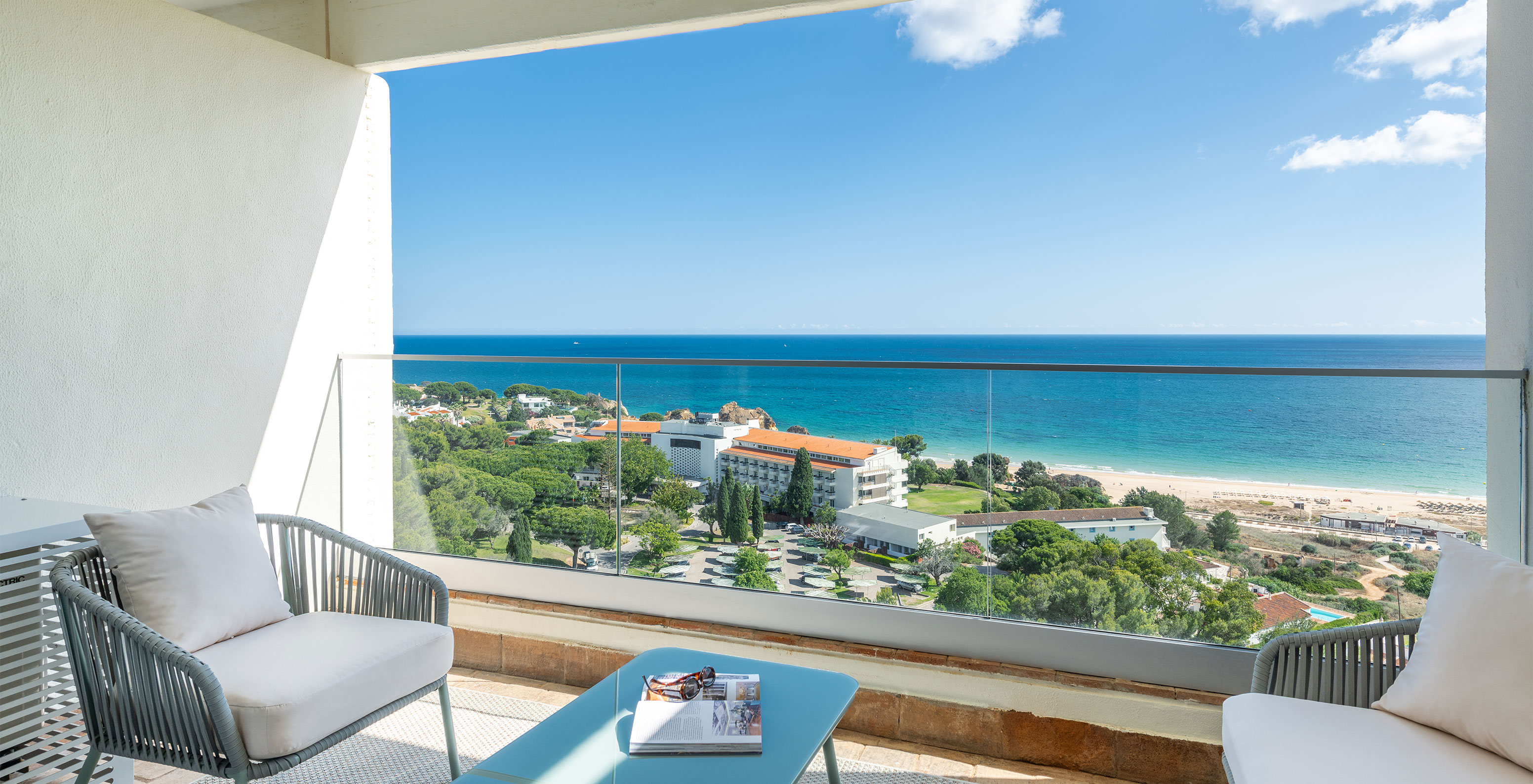 The Superior Family Sea View Room at Pestana Blue Alvor Beach has a balcony with a table and two chairs, and a sea view