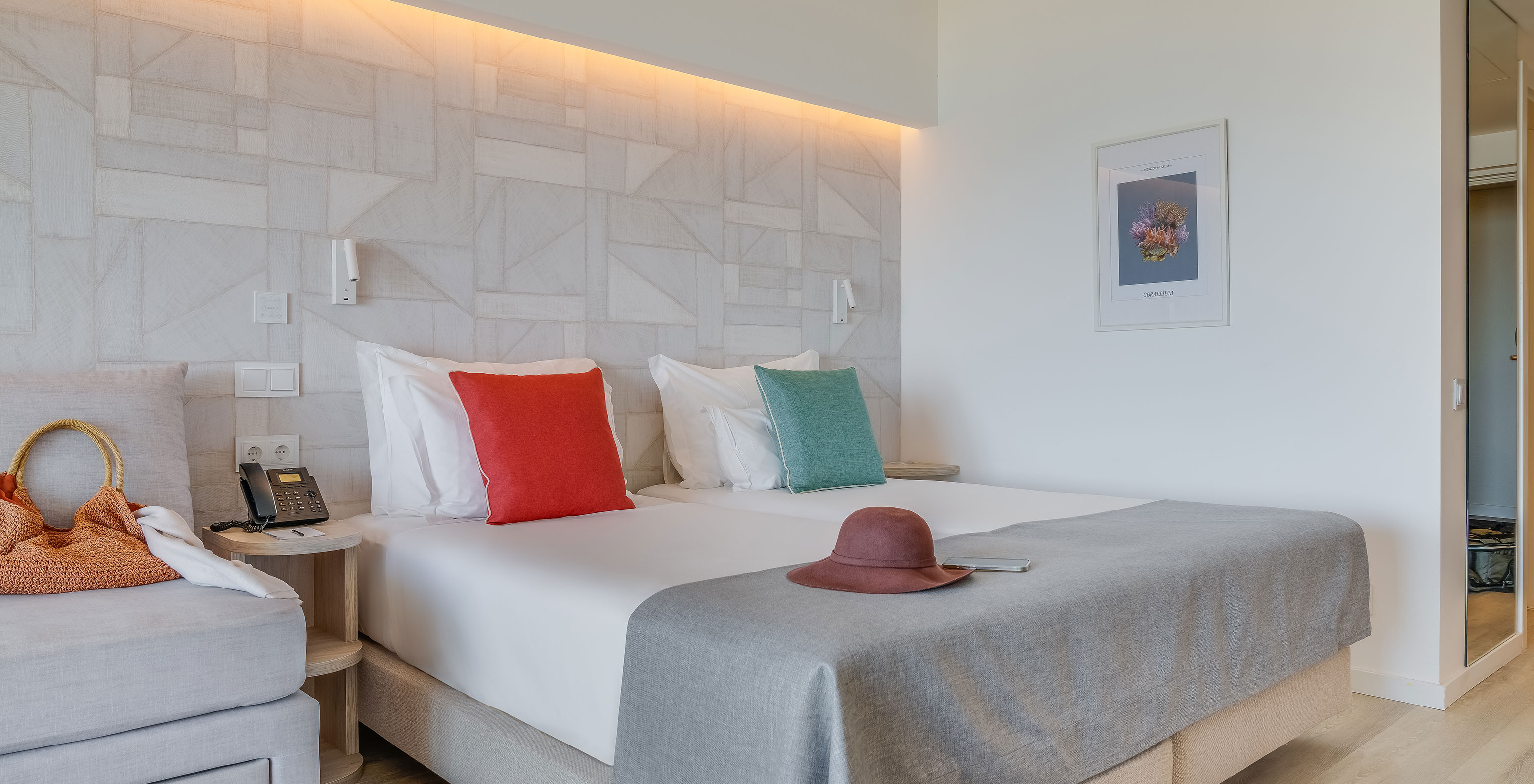 The Family Room at Pestana Blue Alvor Beach has two single beds, a picture, and a large mirror on the wall