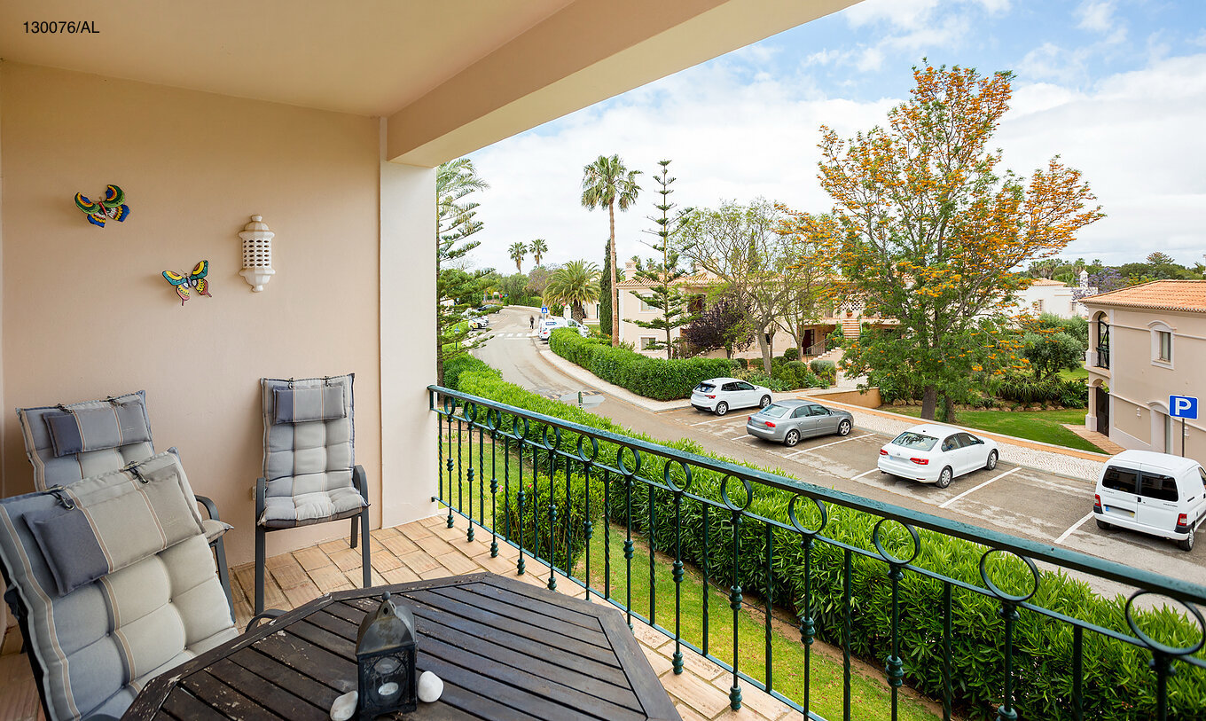 The Pestana Carvoeiro Golf T2 Standard Apartment has a balcony with tables and chairs, with a street view