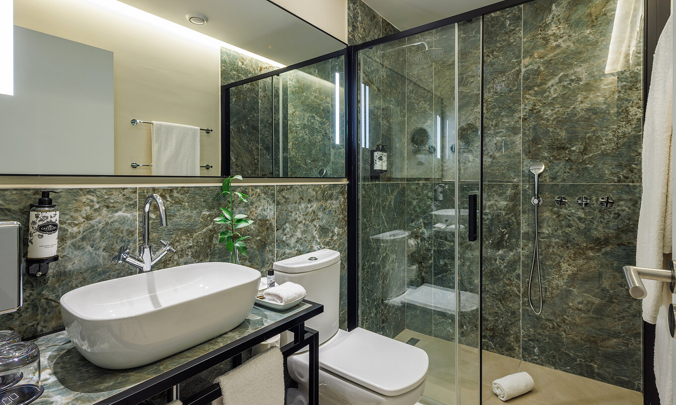 The Classic Garden View at Pestana Vila Sol - Vilamoura has a green marble bathroom with toilet, sink and shower