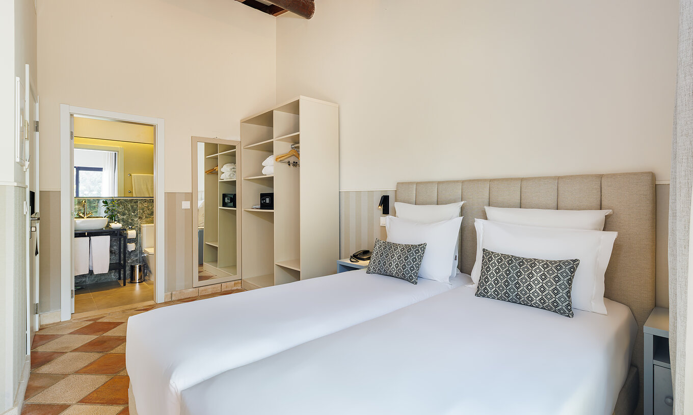 The Family Garden View at Pestana Vila Sol - Vilamoura has two single beds, a mirror and a bathroom