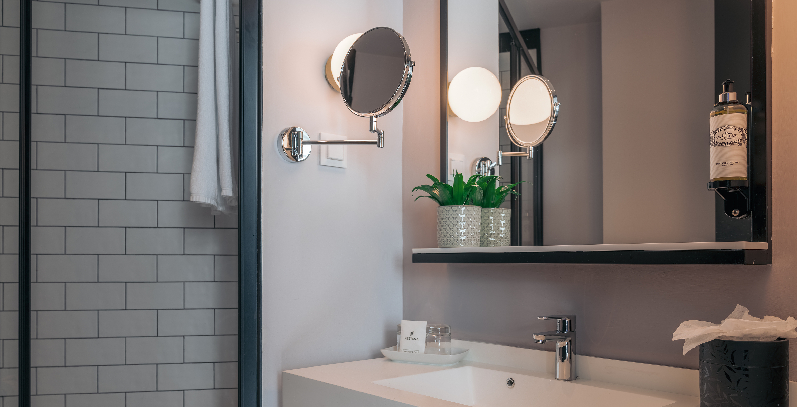 The Double Superior Room at Pestana Lisboa Vintage has a bathroom with sink with two mirrors and a side shower