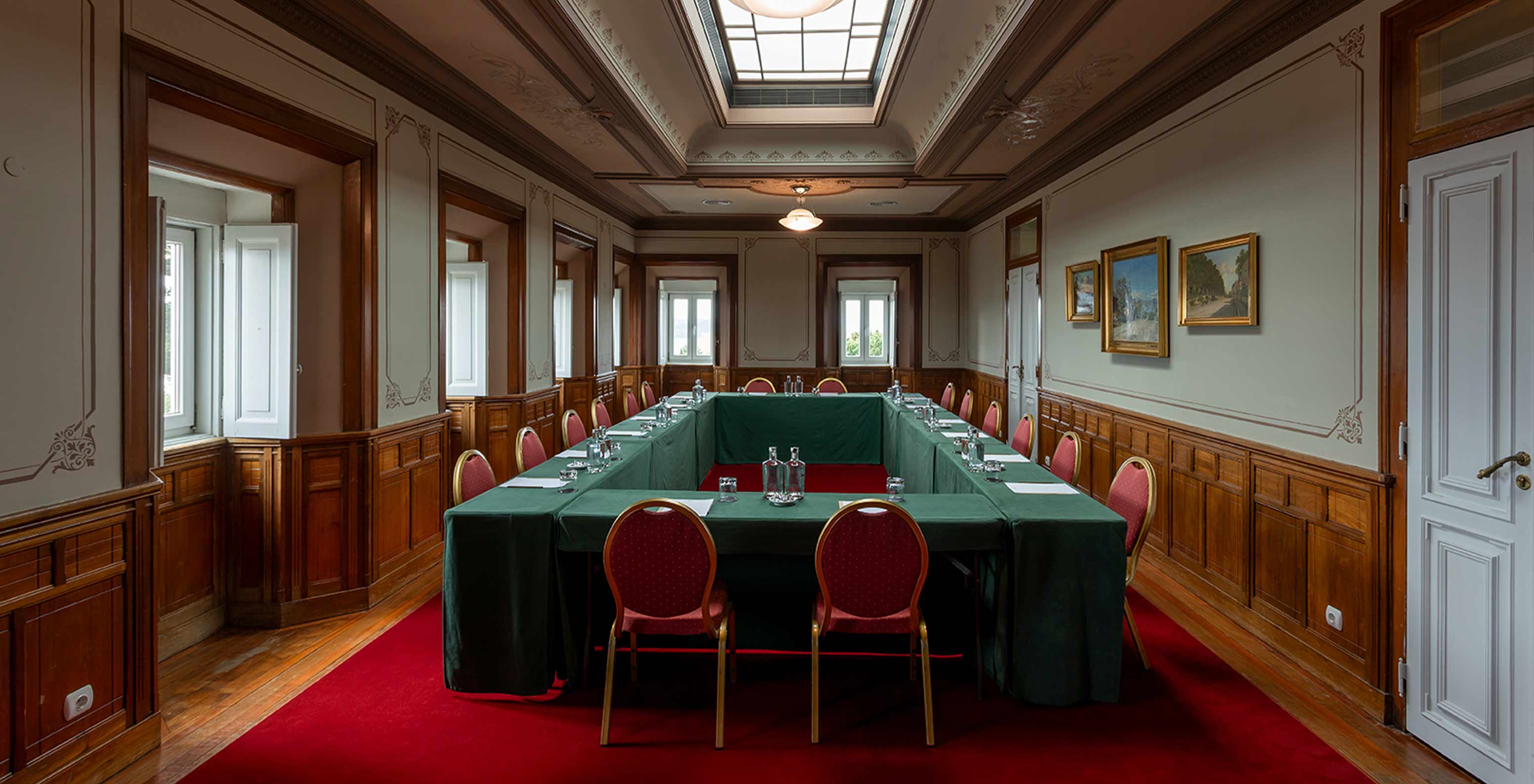 Pestana Palace Lisboa has a meeting room with a large red carpet and a green table