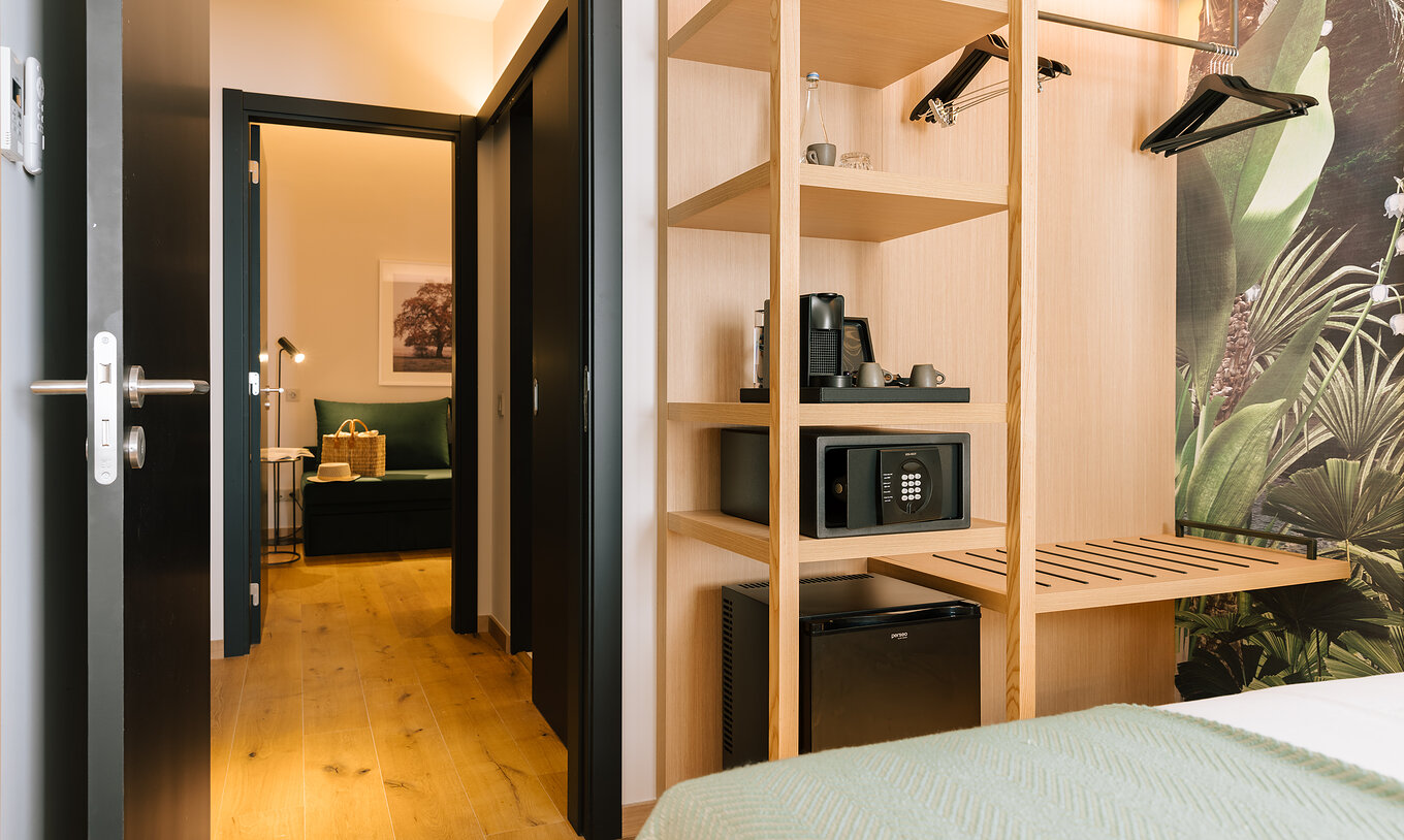 The Family Suite of Pestana Rua Augusta Lisboa has connecting rooms, one of which has a double bed and an open wardrobe