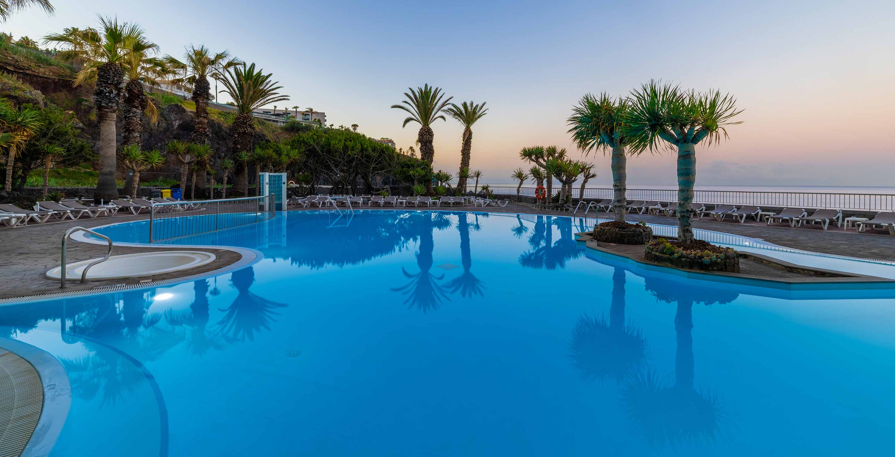 Pestana Ocean Bay All Inclusive, an Oceanfront All-Inclusive Hotel, with a pool and several palm trees