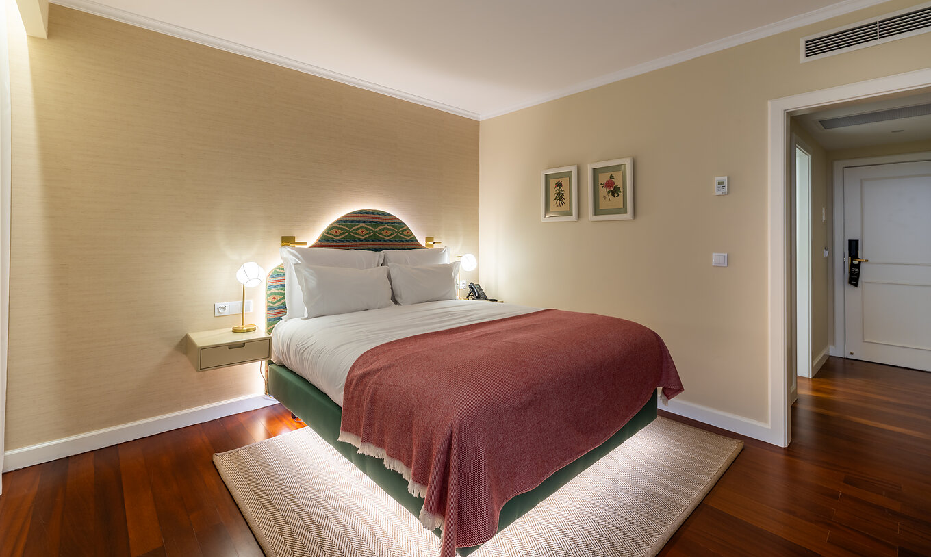 The Partial Sea View Room with Balcony at Pestana Quinta Perestrello has a double bed with a pink bedspread.