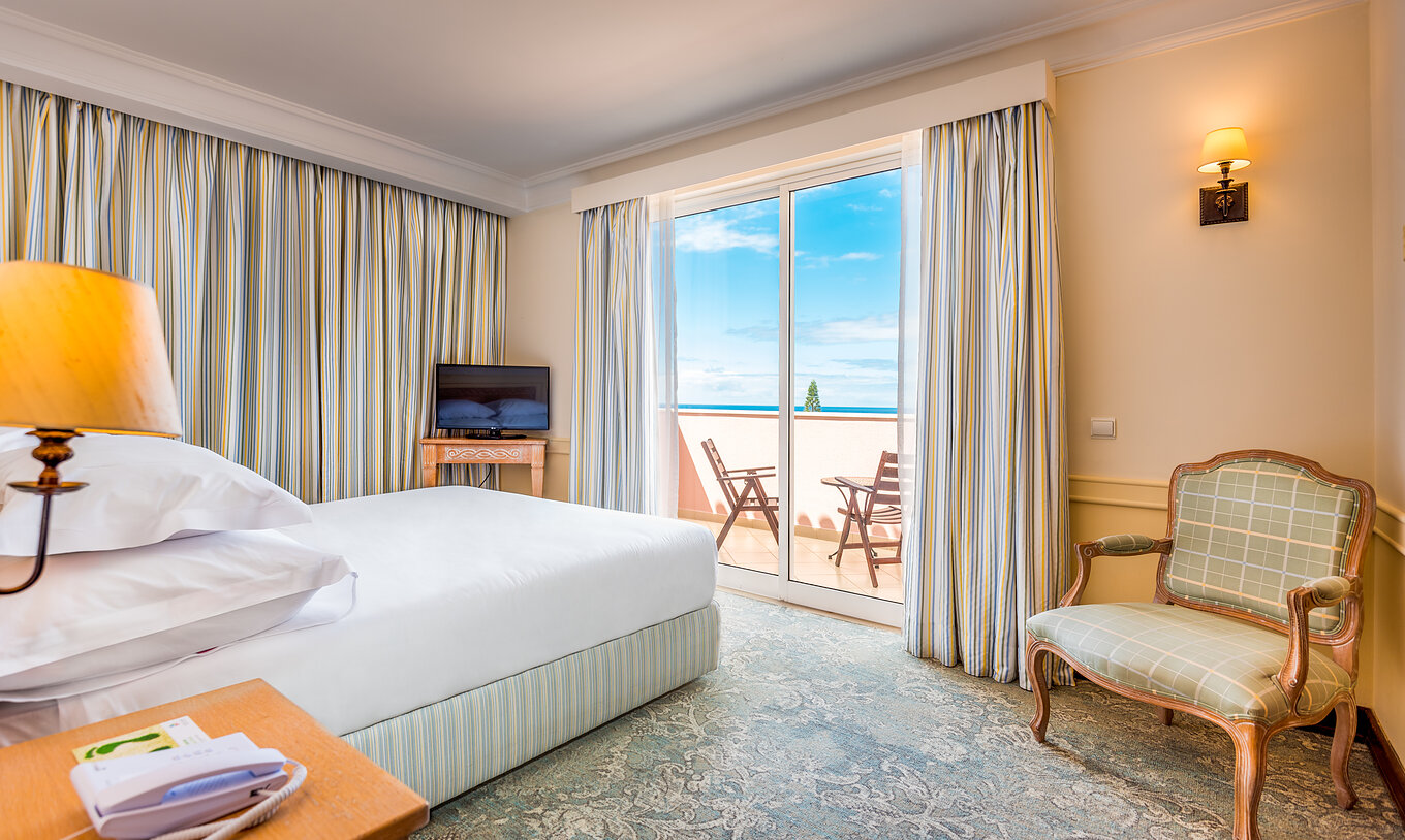 The Deluxe Room with Sea View Balcony of Pestana Royal All Inclusive has a double bed with television and a balcony