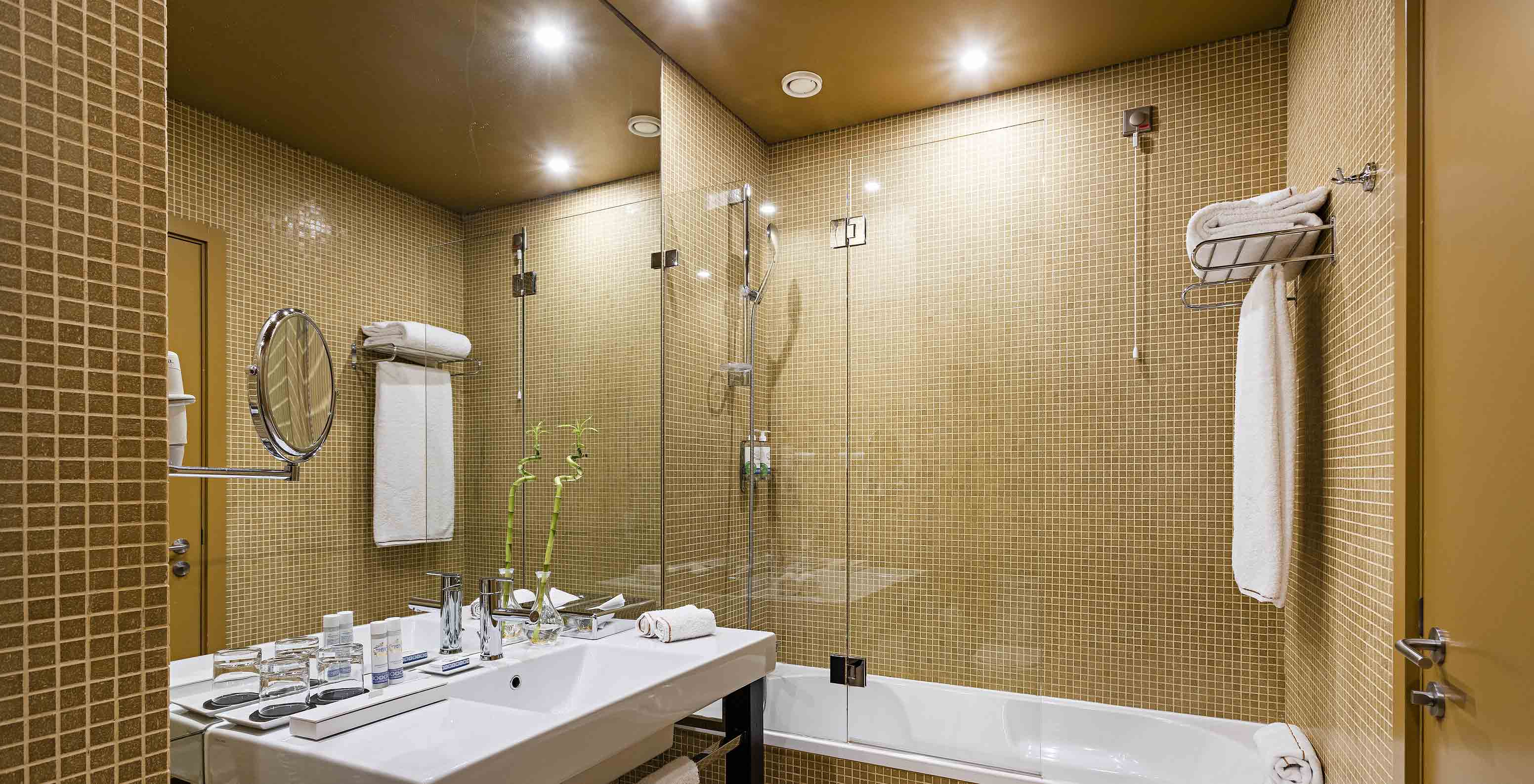 Pestana Palácio do Freixo’s Classic room has a bathroom with yellow tiles, toilet and bathtub