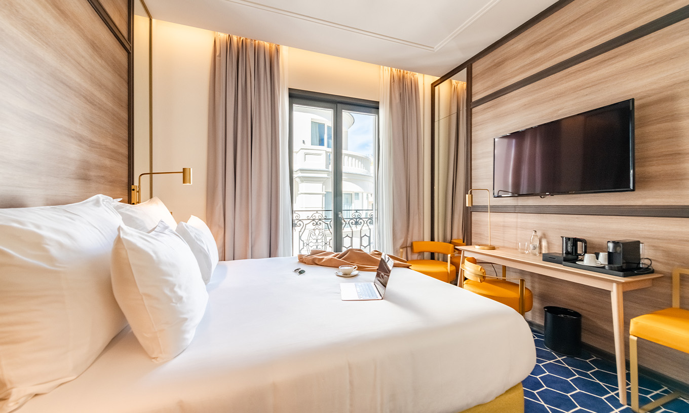 The Premium Room with Balcony at Pestana CR7 Gran Vía Madrid includes a double bed, television, and windows with a view