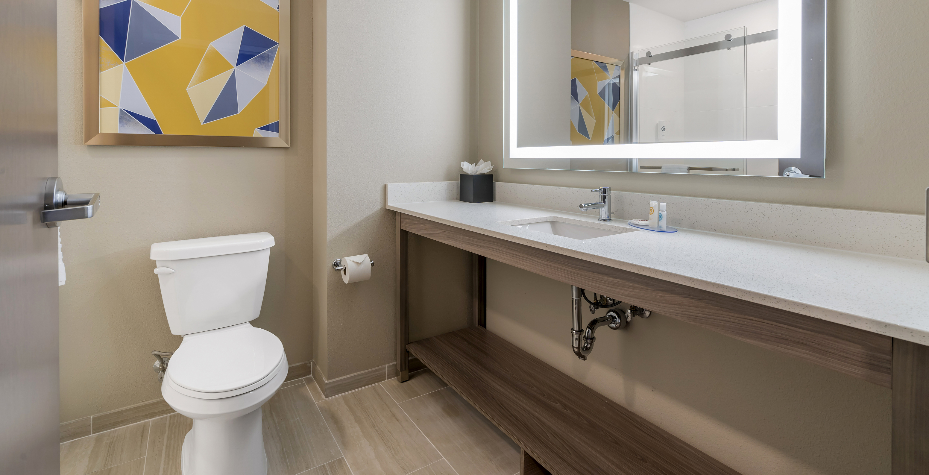 The King Master Suite at Pestana Orlando Suites Lake Buena Vista features a bathroom with a sink, mirror, and toilet
