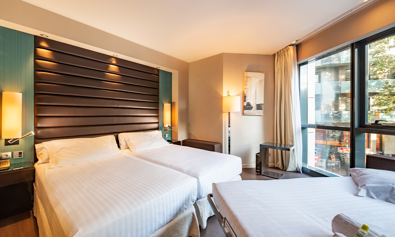El Superior Familiar del Pestana Arena Barcelona tiene una ventana grande, dos camas individuales y una cama extra