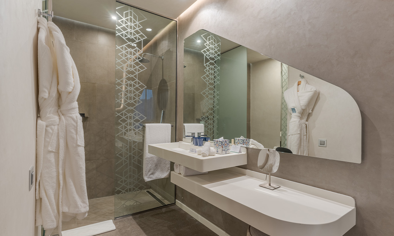 La Suite CR7 Junior Avenue del Pestana CR7 Marrakech tiene un baño con lavabo, espejo, ducha, amenities