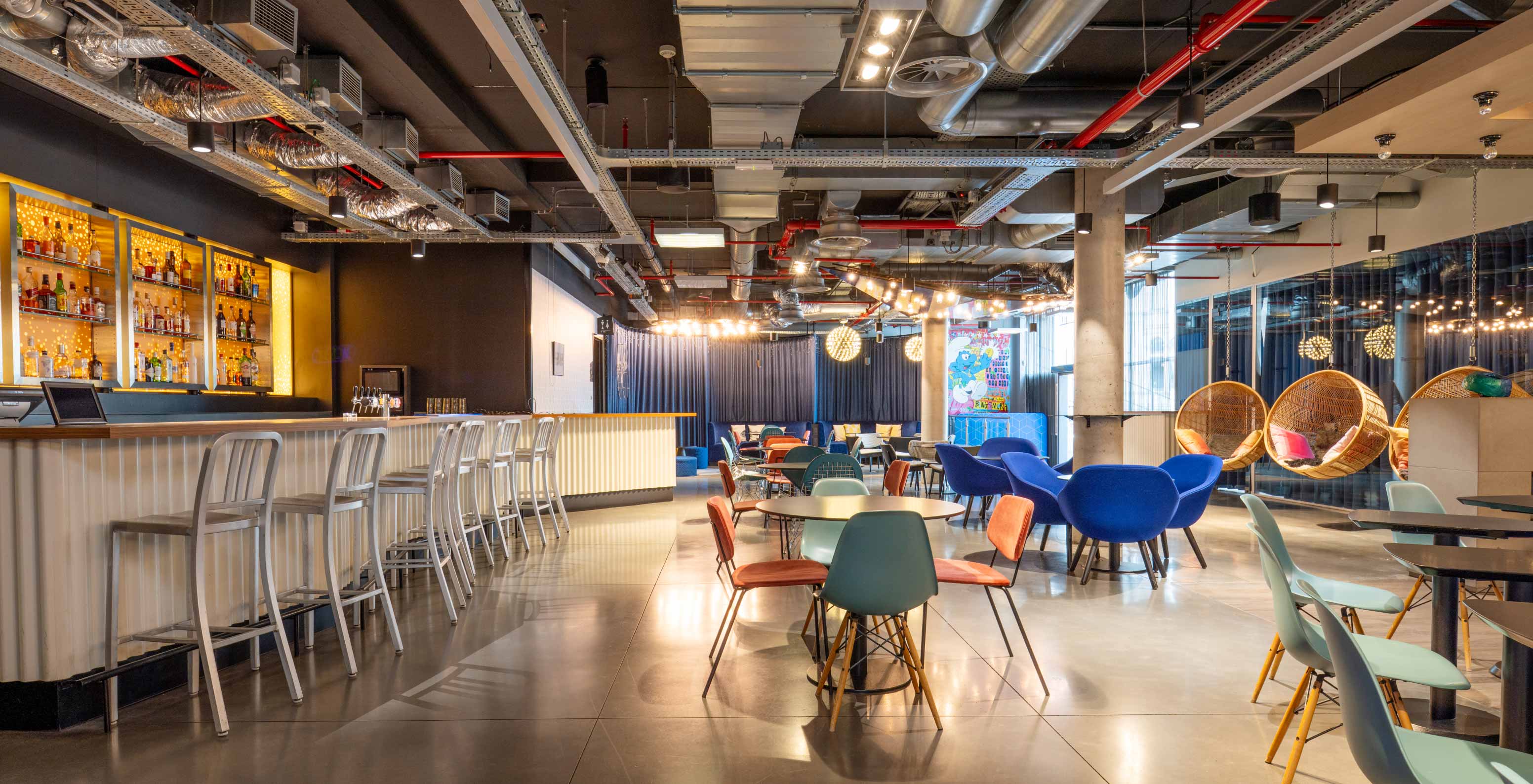 Le bar de l'hôtel à Bruxelles près du Parlement européen a des tabourets hauts et des tables rondes avec chaises