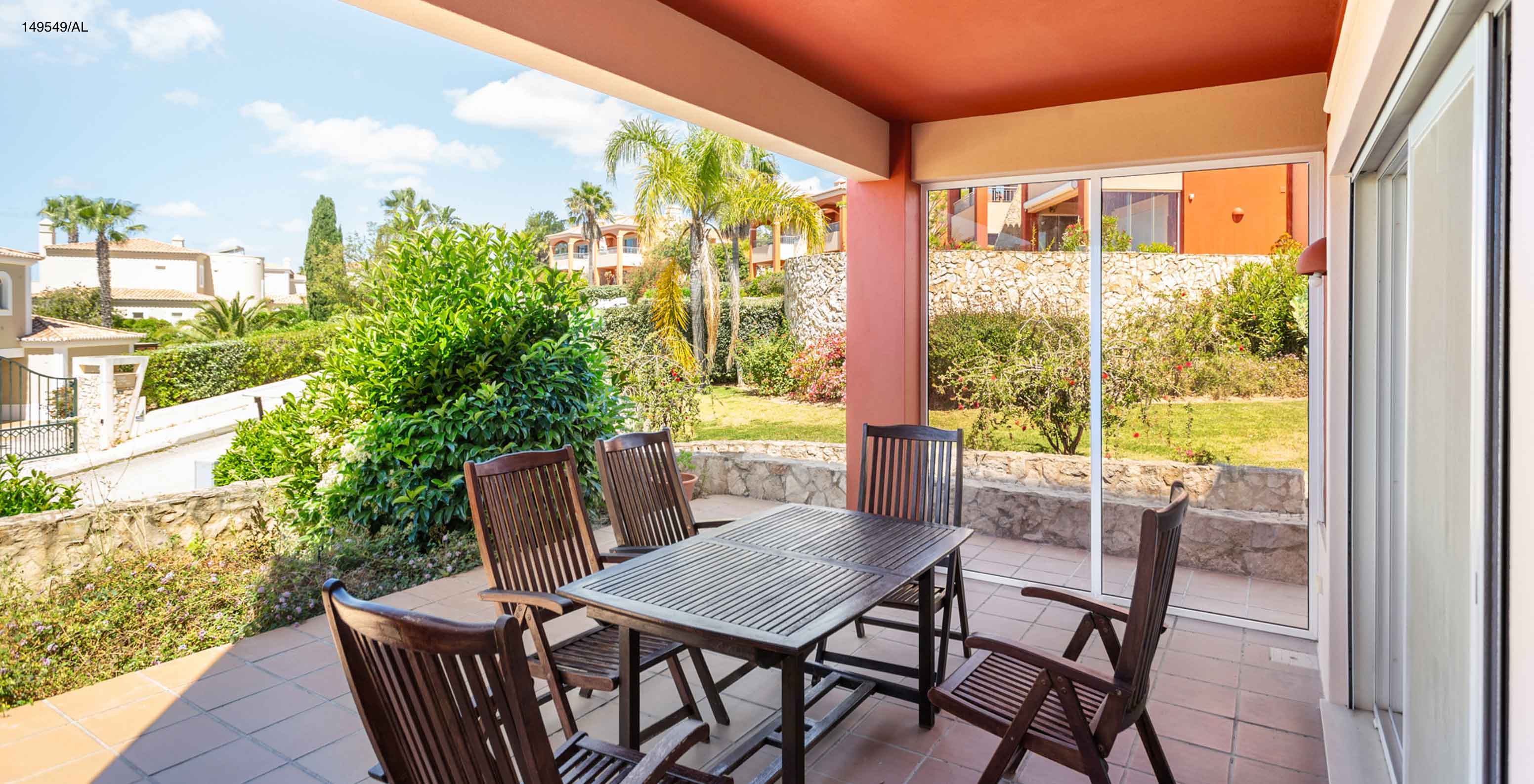 L'appartement Pestana Carvoeiro Golf T2 Superior dispose d'un balcon avec une table et six chaises en bois