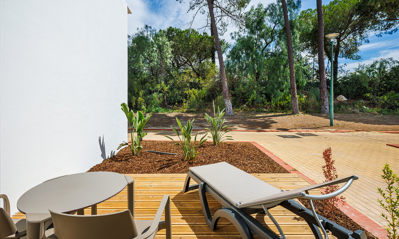 Le Classique Vue Jardin du Pestana Vila Sol - Vilamoura a un balcon avec transat et vue sur la nature