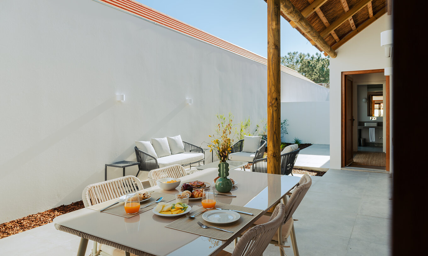 De Superieure Villa bij Pestana Comporta Village Residences heeft een buitenpatio met een eettafel en een bank