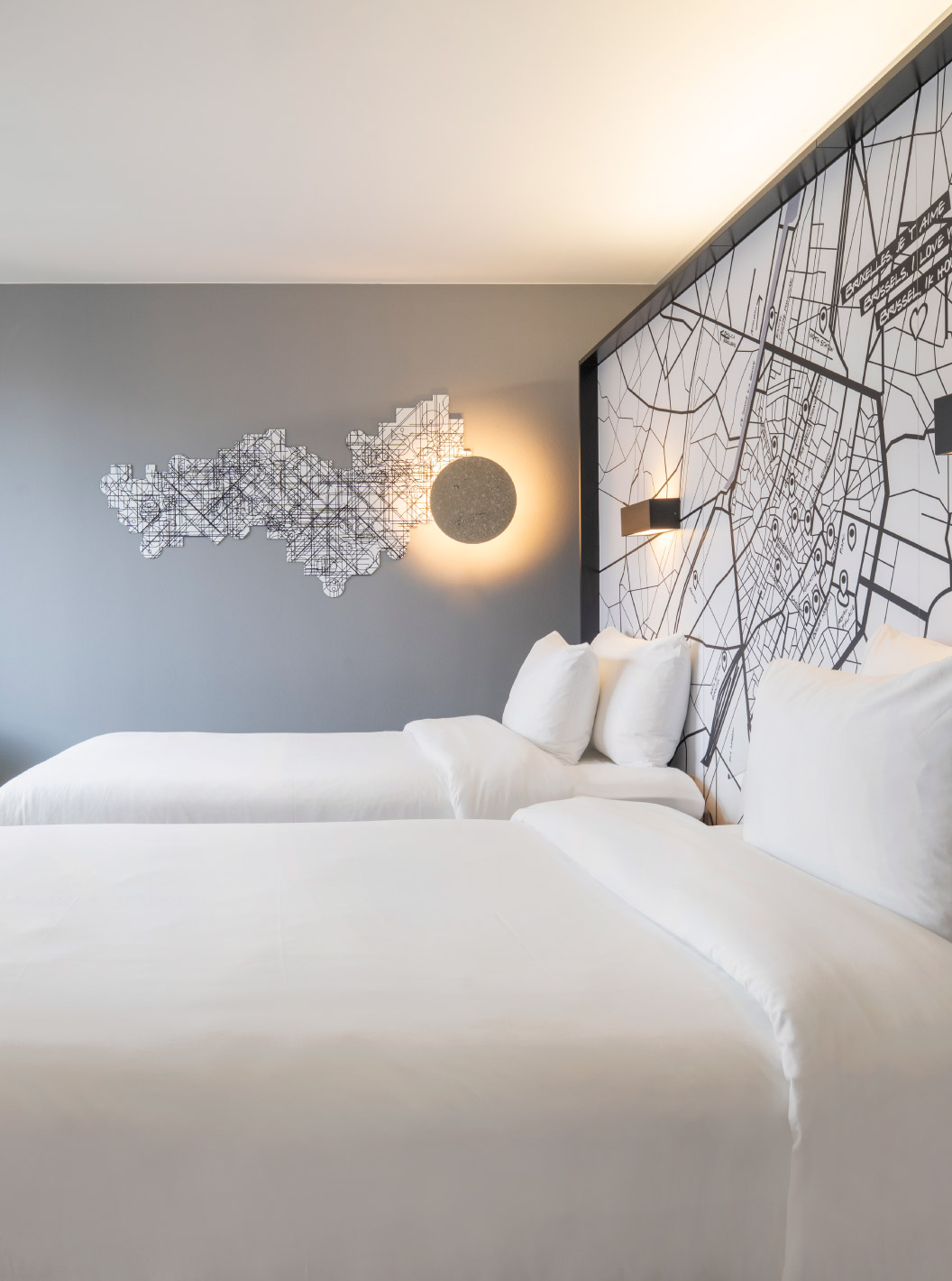 O Standard Twin do Pestana Brussels Schuman tem duas camas individuais, uma cadeira amarela e uma janela com vista