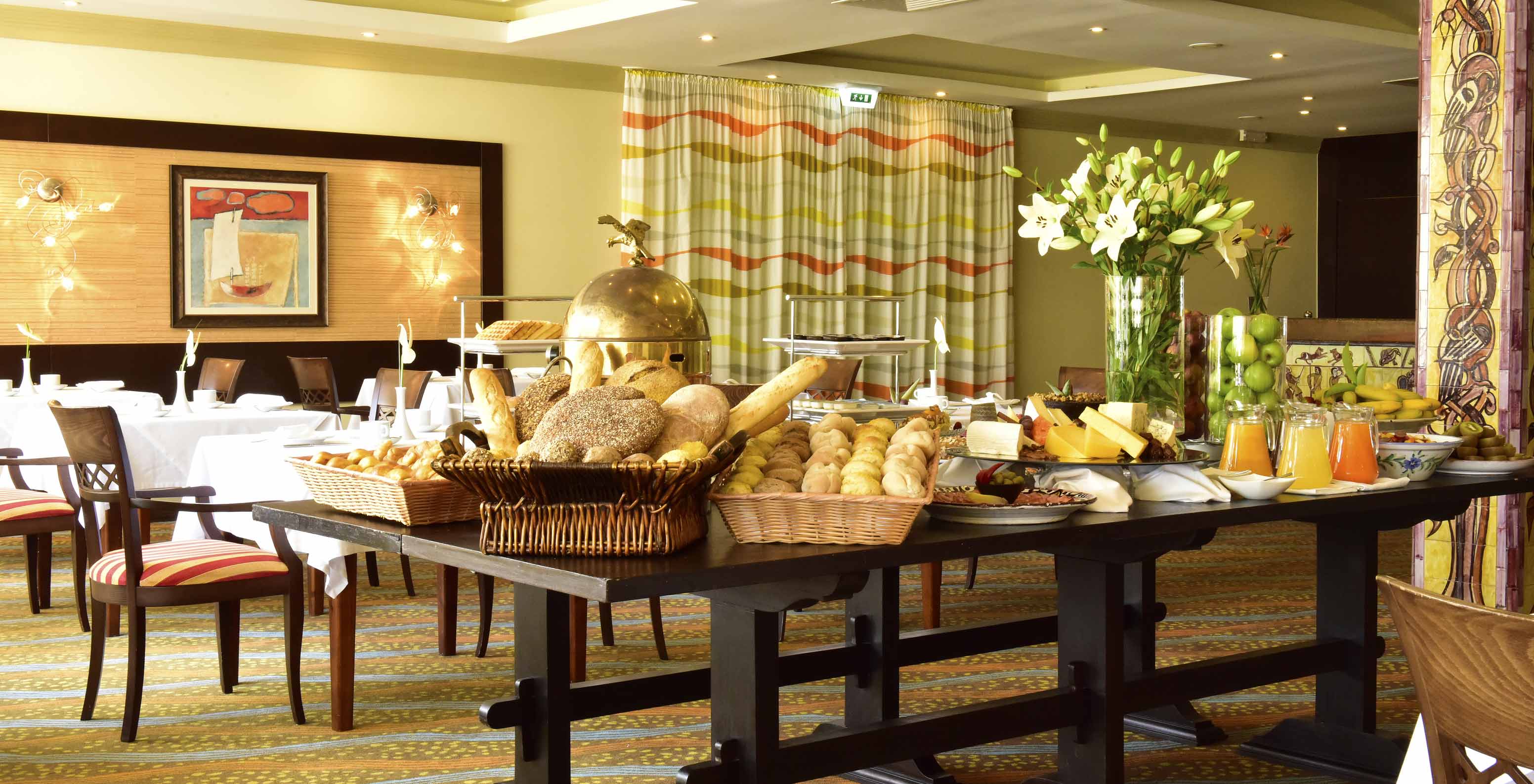 O Pestana Viking, tem uma restaurante com várias cadeiras e mesas para desfrutar de uma refeição variada